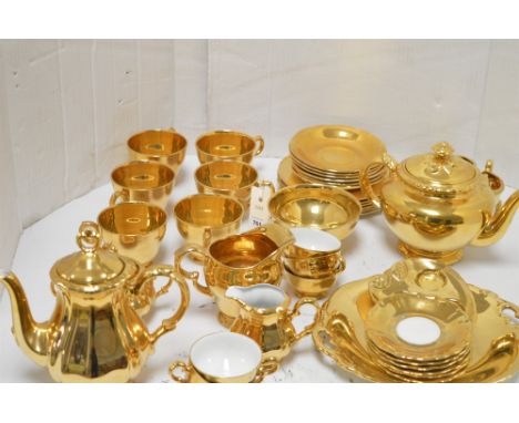 A composite gold tea set by Bareuther, Bavaria; Royal Worcester; and Royal Winton.