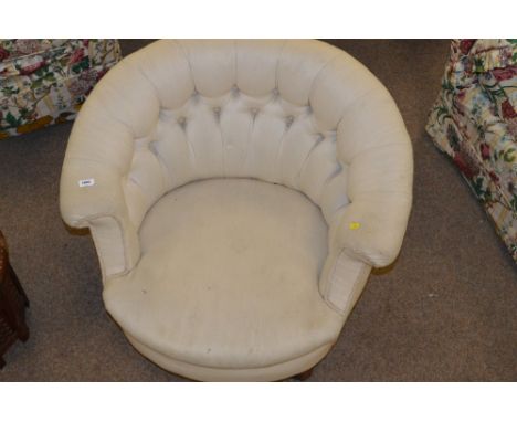 A late Victorian button back tub chair on castors.