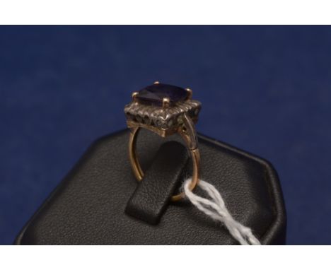 An amethyst ring, the square cut amethyst on yellow metal shank, stamped '18ct'.