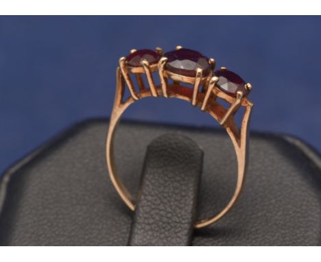 Three stone garnet ring, on 9ct yellow gold shank.