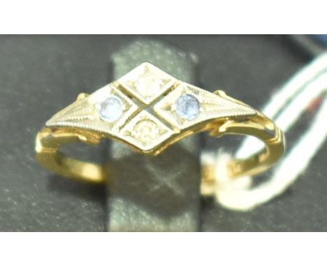 An Edwardian sapphire and diamond ring, the four stones in open white faced mount, shank stamped '18ct'.