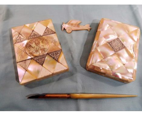 A good mixed lot of mother of pearl items to include two card cases with white metal inserts (possibly silver), a pen and a b