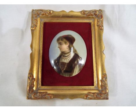 A 19th century hand painted porcelain portrait plaque of a European girl in Renaissance dress