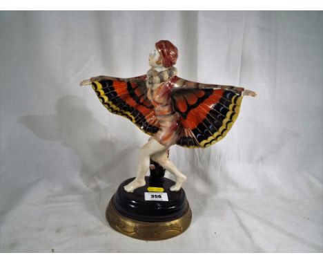 An Art Deco style lady glazed ceramic figurine of the Butterfly Girl in the style of Josef Lorenzl, the figure is supported b