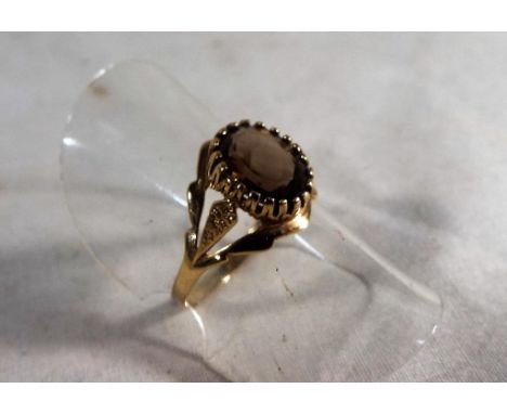 A lady's hallmarked 9ct gold ring with smoky quartz solitaire, approx 1.6 grams, size N, boxed