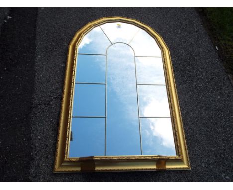 Gilt framed, arched mirror with leaded window design and shelf, mirror size 90 cm x 54 cm