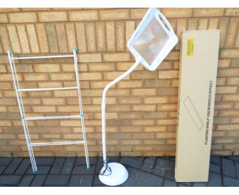 A mixed lot to include a beech effect floating shelf 120 cm (w) sealed in packaging, an airer, and a large magnifying lens on