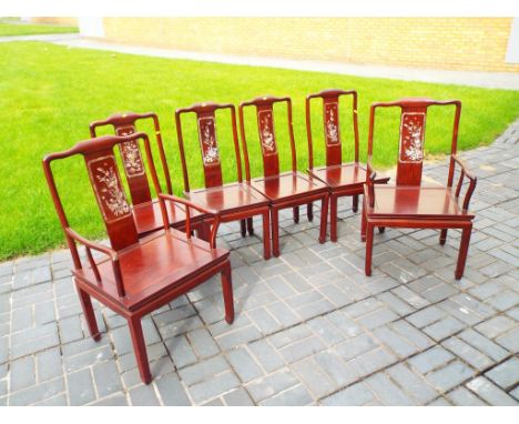 A good quality set of mahogany Asian dining chairs comprising four chairs and two carvers with detailed inlay mother of pearl