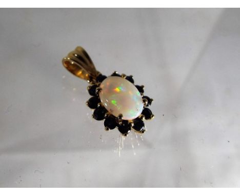 A lady's hallmarked 9ct gold opal and sapphire pendant, approx weight 1.3 grams