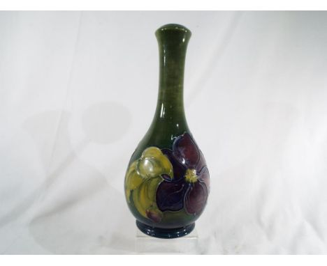 Moorcroft Pottery - a large lamp base decorated with green clematis, 28 cm (h). Estimate £60 - £90