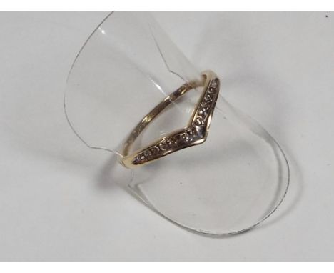 A lady's hallmarked 9 carat yellow gold wishbone ring set with 13 10 pt diamonds, size O + 1/2, approx 1.2 gm (all in) in cas