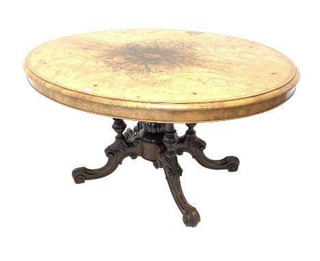 Victorian inlaid walnut oval loo table, the quarter sawn veneered and moulded top raised on four column supports with central