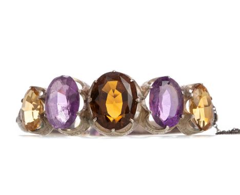IMPRESSIVE AMETHYST AND CITRINE BANGLE,set with alternating stones, engraved decoration to the shoulders, unmarkedGenerally w