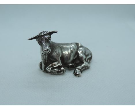 An early Victorian Novelty Silver Snuff Box, modelled as a laying bull, with hinged opening to base. It is hallmarked for She