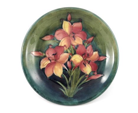 Walter Moorcroft, a Freesia plate, circa 1940, green ground, everted rim, impressed marks and facsimile signature, underglaze