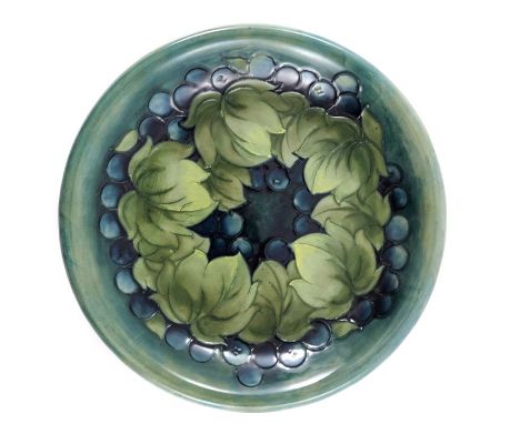 William Moorcroft, a Leaf and Berry plate, circa 1930, teal ground and green leaves with everted rim, impressed marks and und