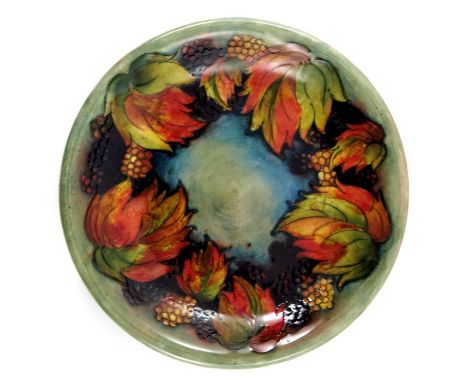 William Moorcroft, a Flambe Leaf and Blackberry plate, circa 1930, green ground with everted rim, impressed marks and facsimi