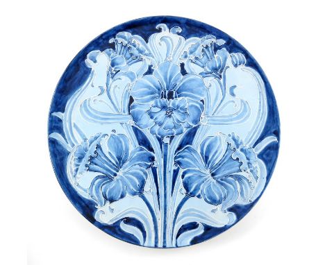 William Moorcroft for James MacIntyre, a Florian Ware Daffodil wall plate, circa 1900, circular form with suspension holes to