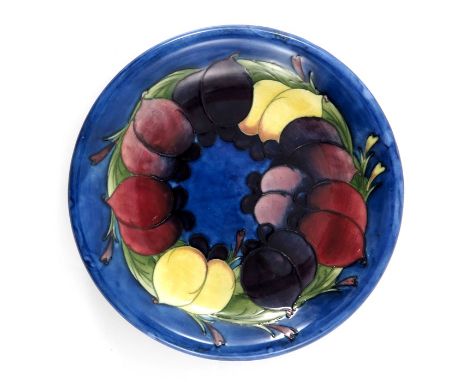 William Moorcroft, a Wisteria plate, circa 1928, blue ground with everted rim, impressed marks and underglaze blue monogram, 