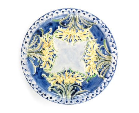 William Moorcroft for James MacIntyre, a Florian Ware Cornflower plate, circa 1902, blue ground, fish scale rim, printed mark