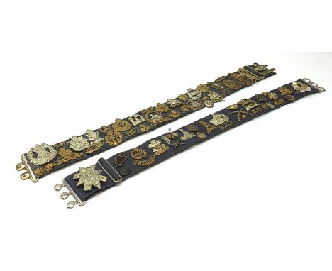 Collection of Glengarry and cap badges, shoulder titles, collar dogs, buttons etc mounted on two military belts, including ra
