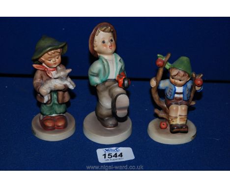 Three Goebel figures including a boy with umbrella, 'Apple Tree Boy', and a boy with a lamb