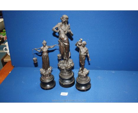 Three Spelter Figures on turned ebonised wooden plinths including a Gent carrying an urn, a lady with yoke and buckets and a 