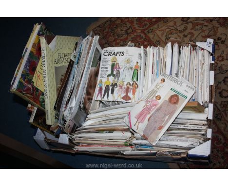 A box of vintage sewing patterns and books, etc.