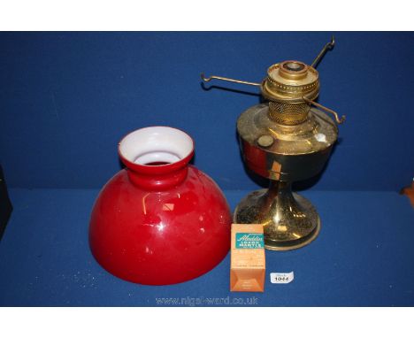 An Oil Lamp with red shade (as found)