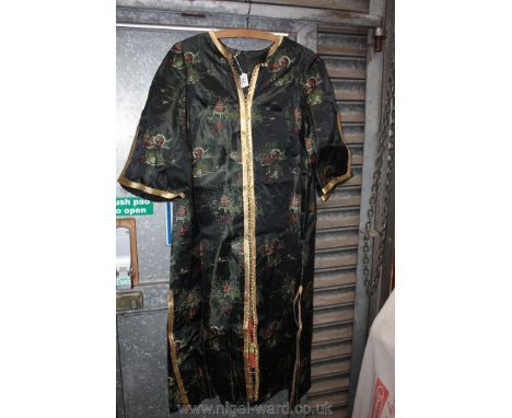A Superb Vintage Black Silk Kimono Decorated with Garden Scenes of Geisha and Pagodas with Gold Braid Buttons and Trim.