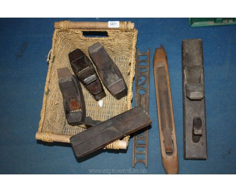 A basket of vintage wood tools including planes, levels, etc