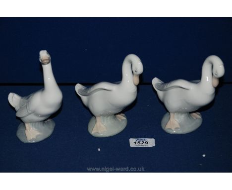 Two Nao (by Lladro) Swan figures plus a similar Duck figure