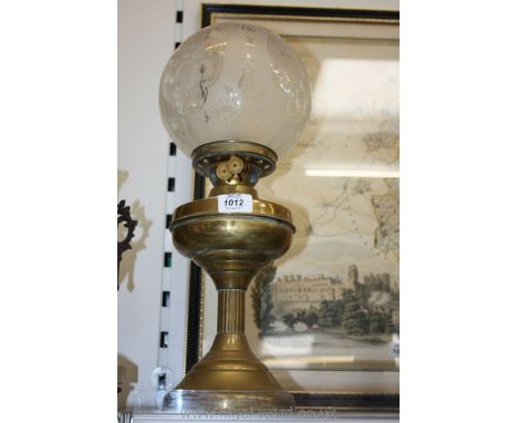 A Brass Oil Lamp with etched globe shade