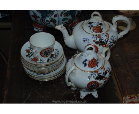 An Imari style Teapot, Sucrier with lid, five plates, eight saucers and cup (reg no 72354)