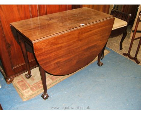 A Georgian Mahogany drop-leaf swing leg Dining Table having rectangular top with deep oval drop leaves and plain frieze and s