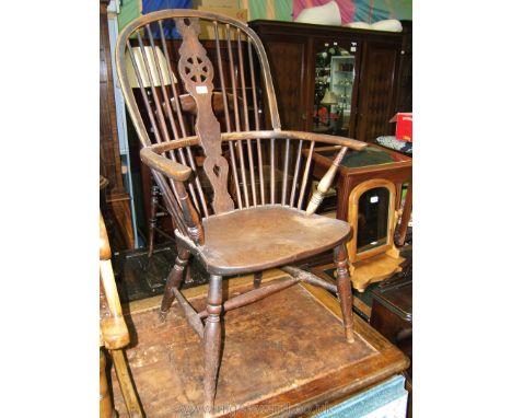 A late 18th c. Elm and Ash Windsor Chair, having bent Ash hoop back and arm, central Oak Wheelback splat with lower piercing,