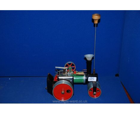 A Mamod Engine live Steam Road Roller complete with spirit burner, wheel drive belt, steering shaft and plastic boiler fillin