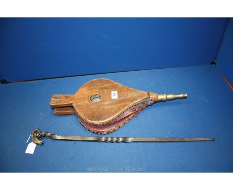 An unusual arts and crafts wrought steel fireside poker with ram's head finial and a vintage set of Elm bellows.