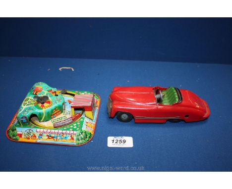 A vintage Triang Minic clockwork towing car with a tinplate clockwork miniature fairground train