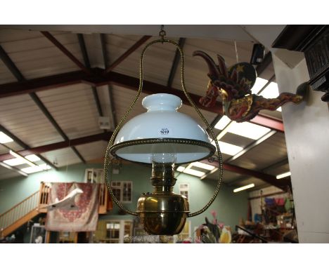 A large hanging Oil Lamp with funnel and white shade