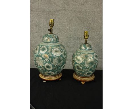 Two teal ceramic table lamps. With hand painted floral decoration and delicate gilt detailing. The largest of the two measure