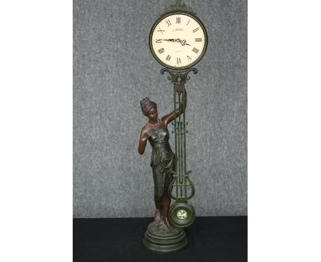 A contemporary Juliana quartz pendulum figural table clock in a bronzed finish. 71 cm. 