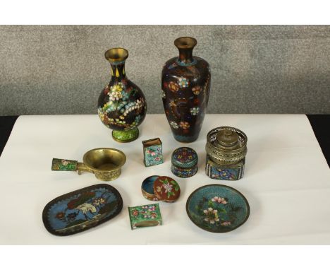 A collection of enamel pots and boxes with floral decoration. A mix of Persian, Japanese and Chinese styles. The largest with