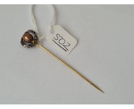 An antique black pearl &amp; diamond stick pin in high carat gold 