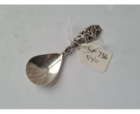 A decorative caddy spoon with vine handle hammered bowl Birmingham