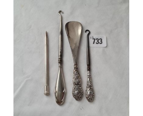 A engine turned propelling pencil and three silver handled items