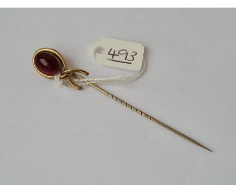 A cabachon  garnet stick pin in high carat gold