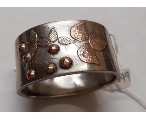 A silver wide bangle with gold overlay