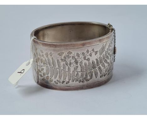 A very wide silver bangle with fern engraving - 39gms