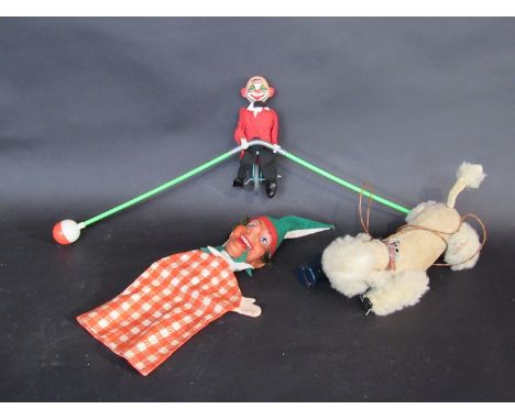 A battery operated dog, Punch glove puppet and balancing clown